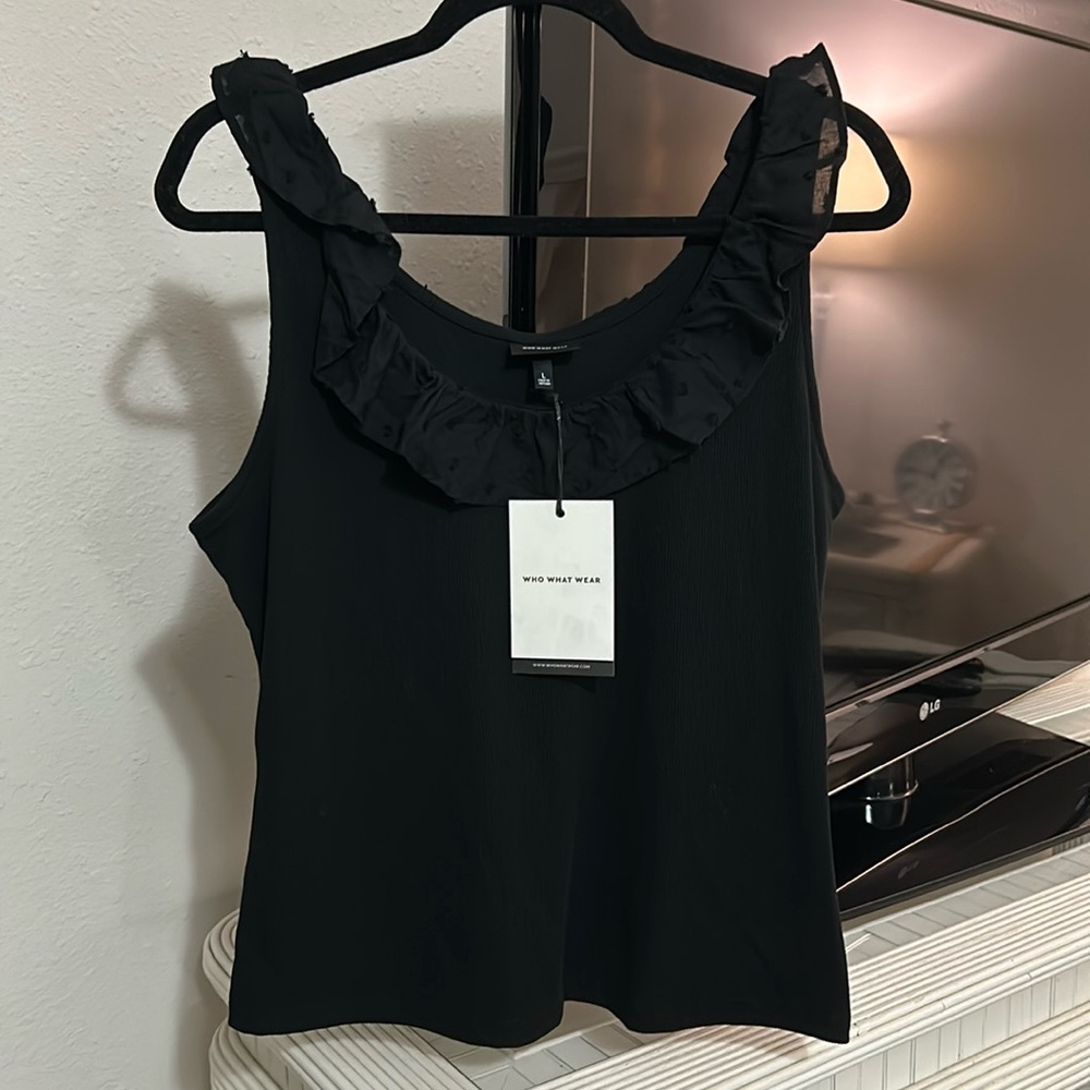 Who what wear brand new beautiful black tank- stretchy with ruffle edge. New.